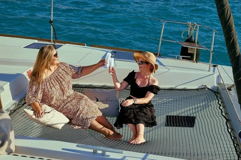 two women relaxing on board of a catamaran